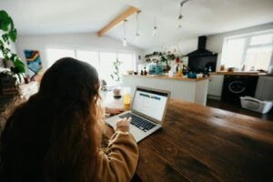 doing job interview assignment on laptop in kitchen