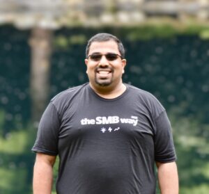 man in black t shirt and sun glasses outside smiling