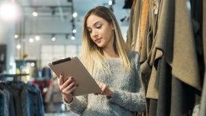 Woman employee using tablet in retail store