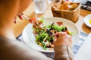 Woman eating salad at a restaurant