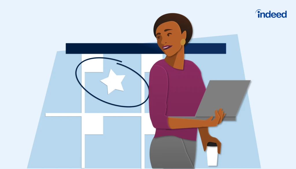 A smiling employee working on a computer