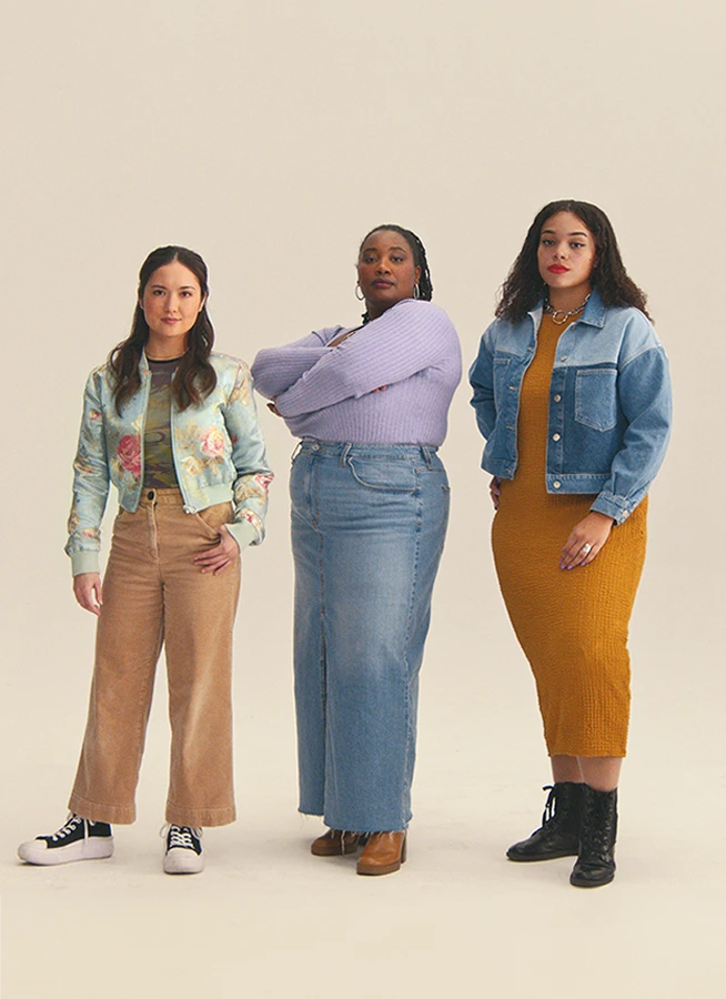 Three women standing and looking directly at the camera