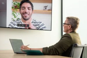 Hiring manager conducting video interview in conference room