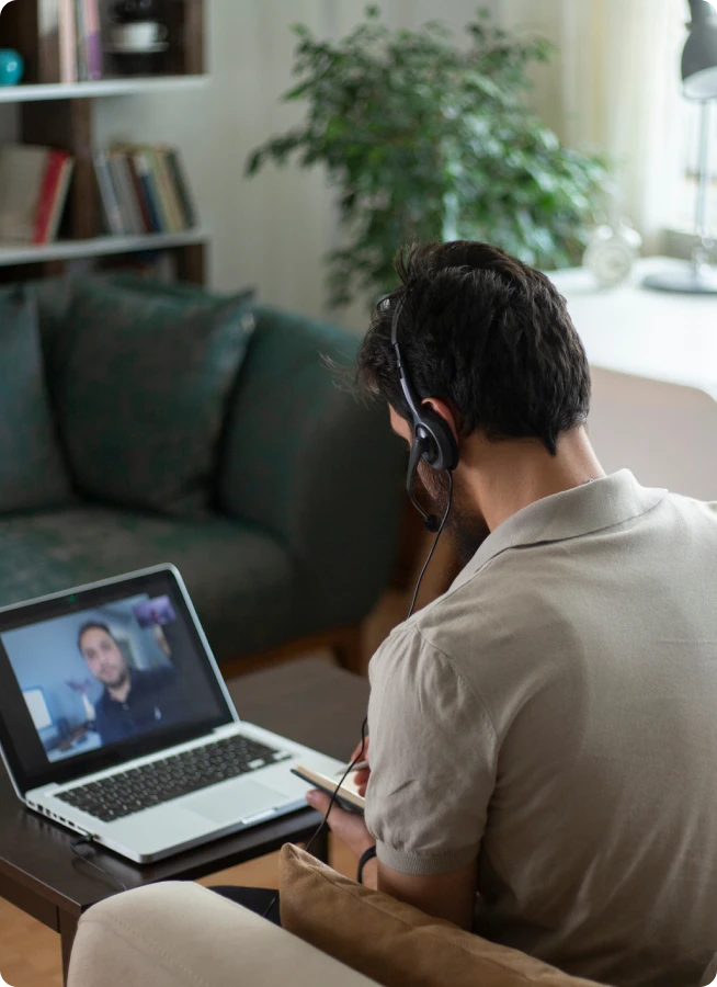 Over shoulder view of a man on a video call