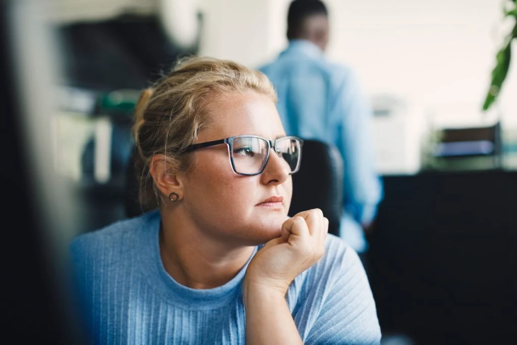 Woman looking off into the distance at work.