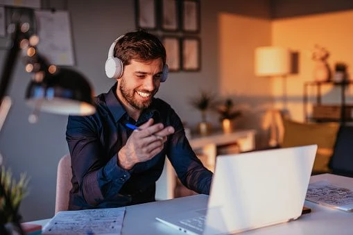A man on a video call in his home office.
