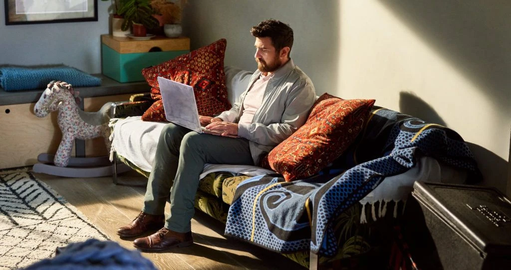 Mature man with beard working from home on laptop