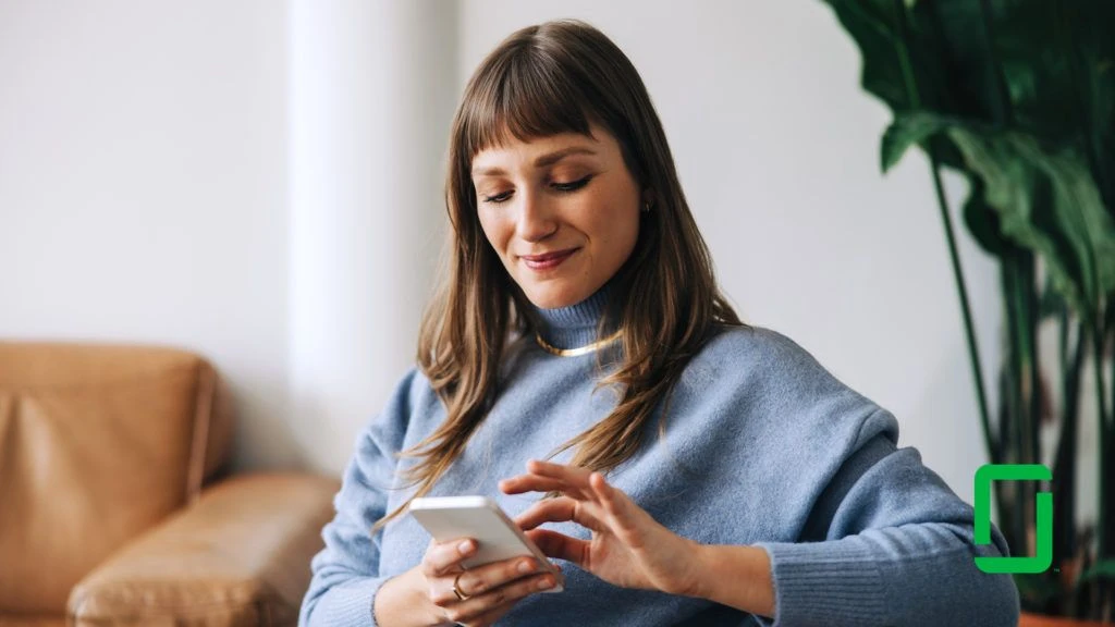 Woman smiling looking at her mobile device