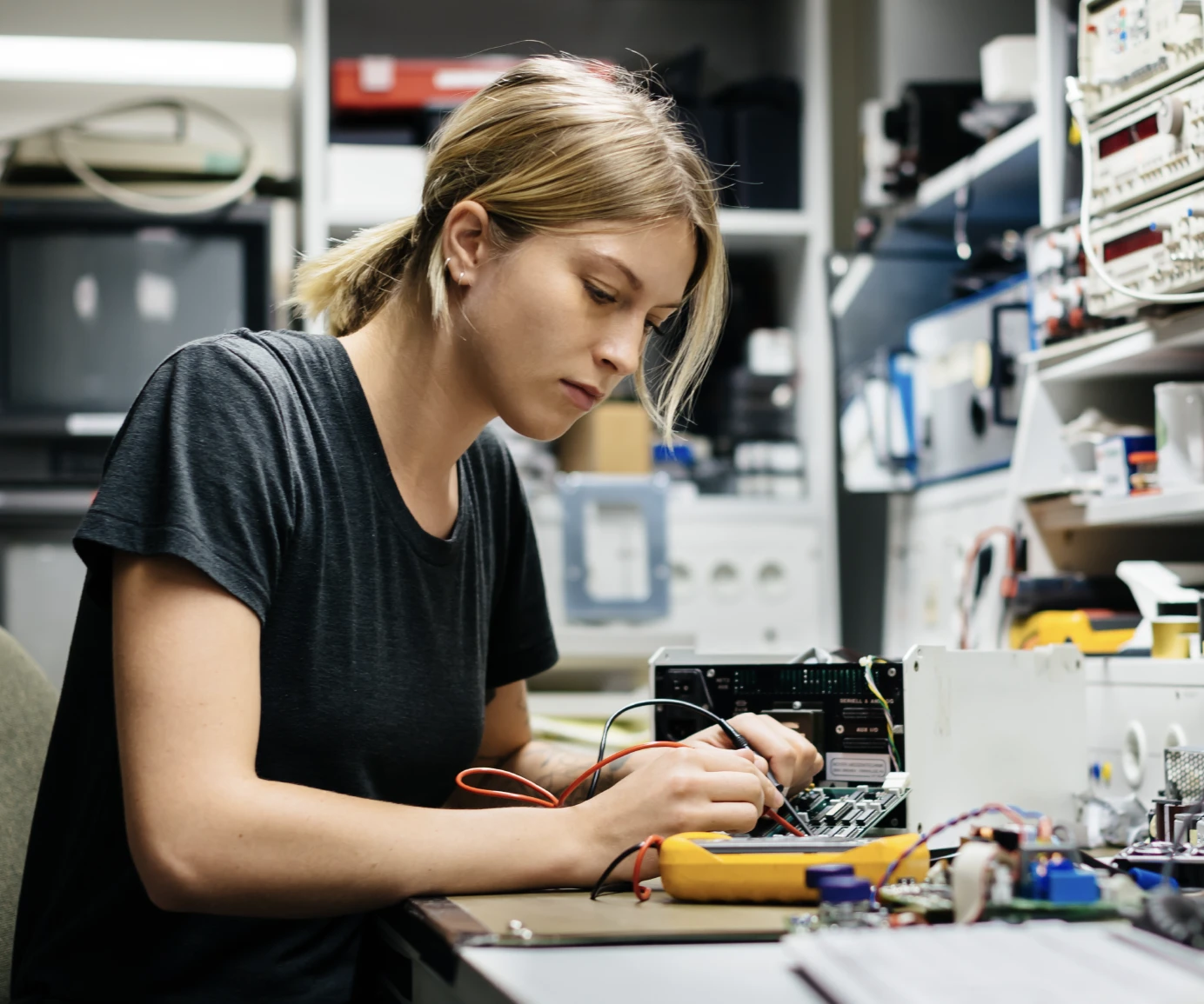 Person working on circuit board at work