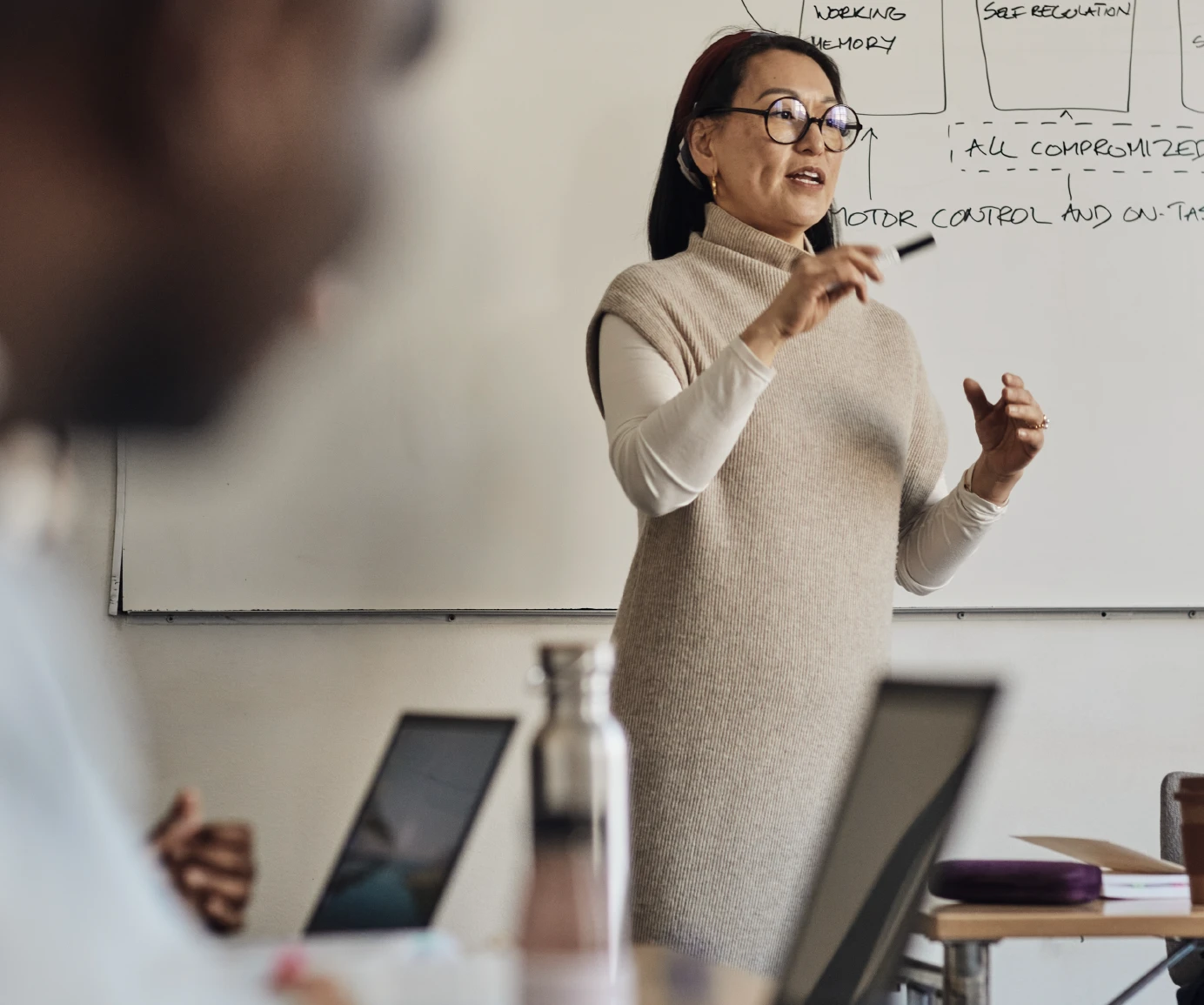 Person up in front of room and presenting/teaching others