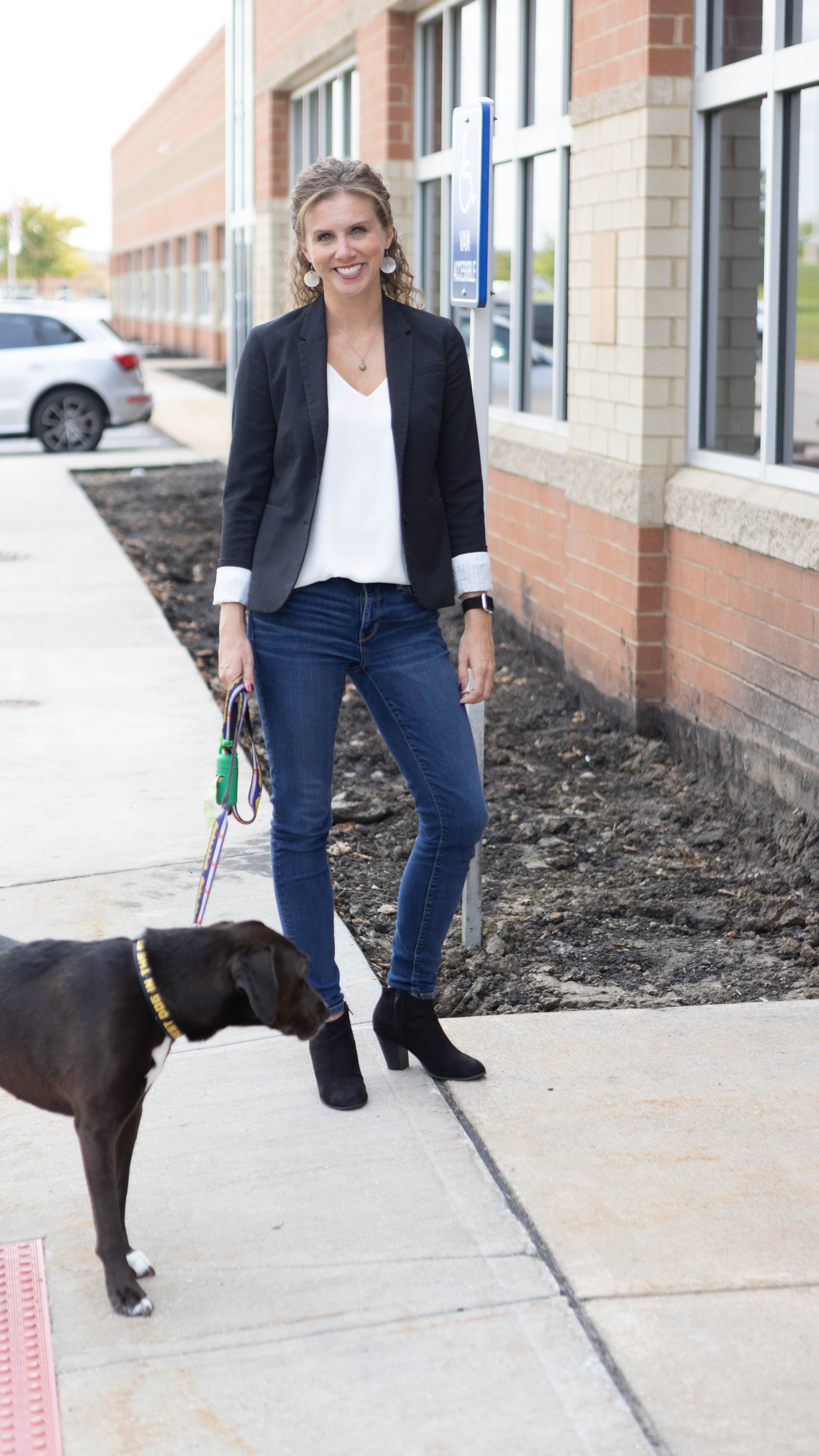 embrace pet insurance chief of staff walking a black dog