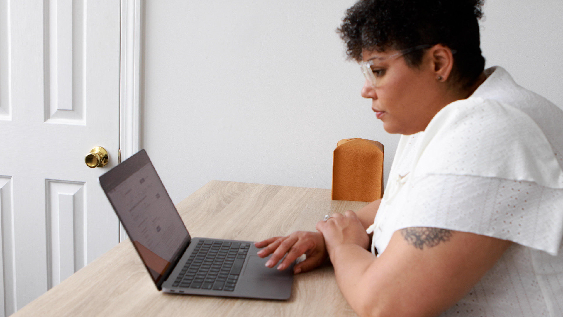 ceo of colorful resilience sitting at a desk working on her laptop