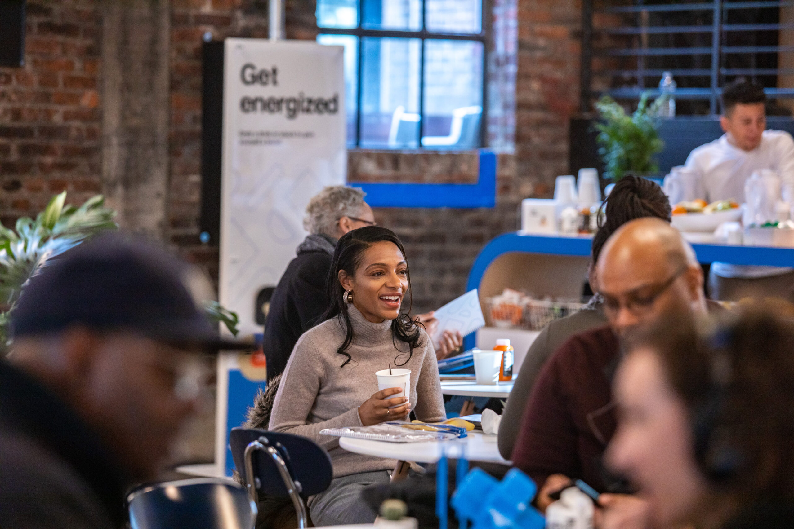 Two people engage in a cheerful conversation at an Indeed event