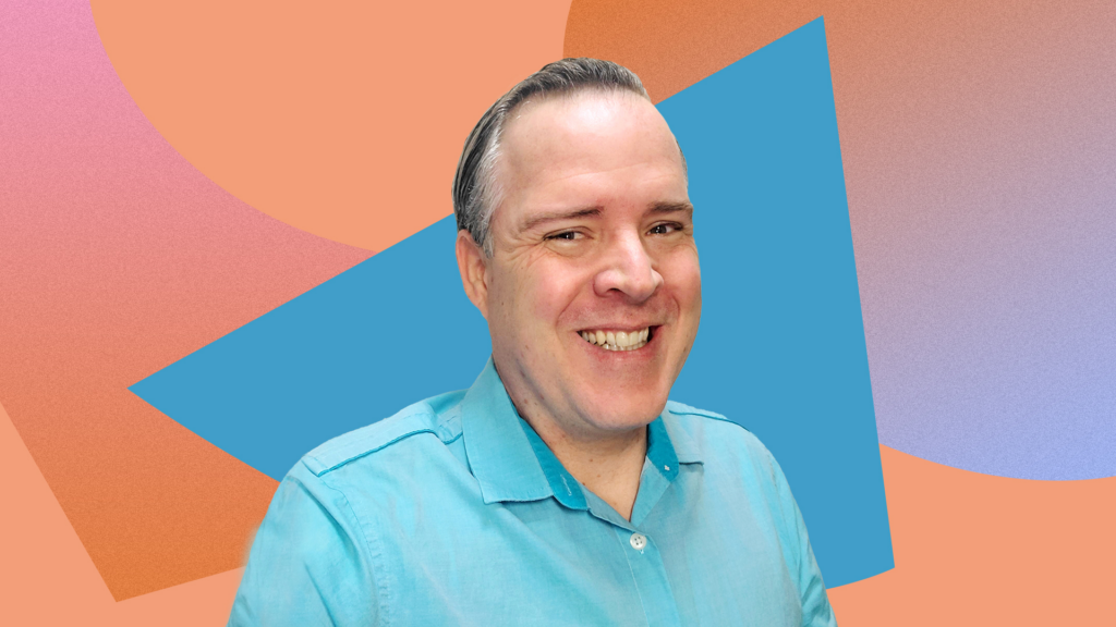 Image is of Erik Kershner. He is a middle aged white man with gray and white hair, smiling into the camera, and wearing a light blue polo shirt. 