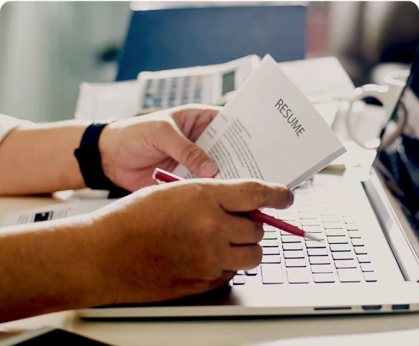 Image of a person holding a group of papers