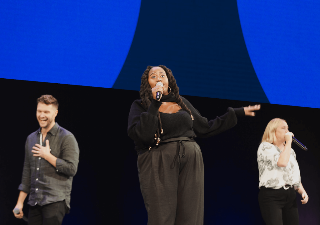 Image of three people performing improvisational comedy  on stage at Futureworks. 