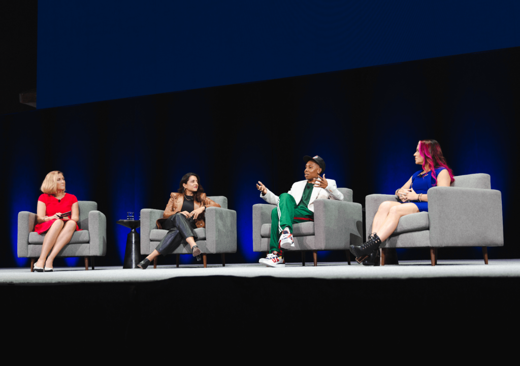 Image of Jessica Jensen, Chief Marketing Officer at Indeed, and three other people sitting in chairs on a stage at Futureworks. 