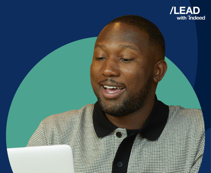 A man gleefully stares at his laptop.