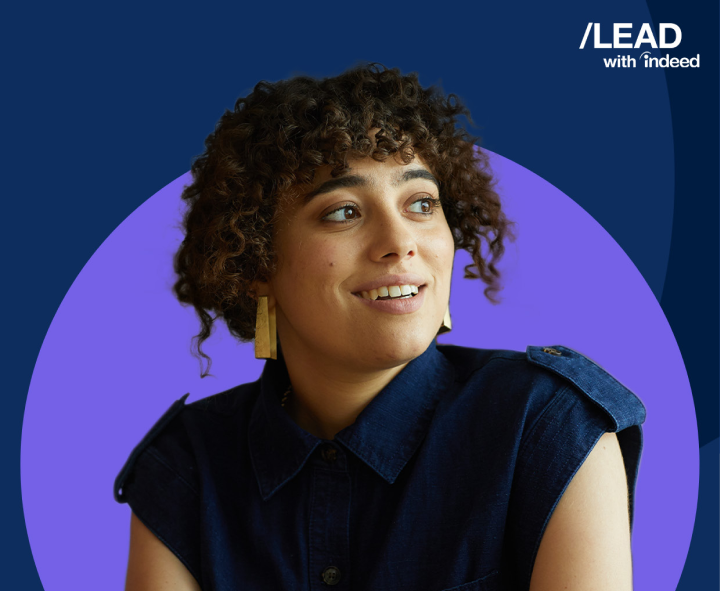 A woman gleefully stares into the distance.