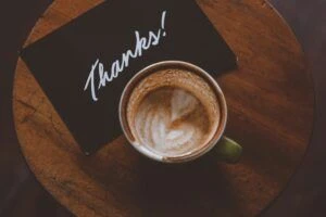 Thank You card next to a cup of coffee