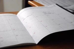 An open day planner on a desk.
