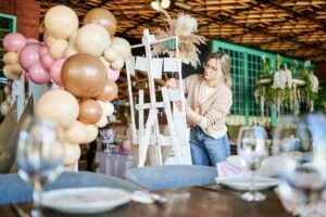 Female party planner arranging decorations for a child birthday party