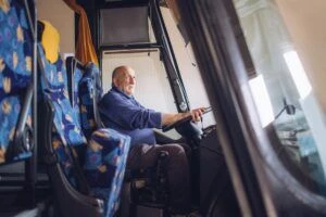 Senior male driver driving bus