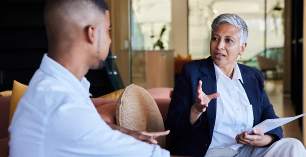 one woman and one man engaged in one to one conversation