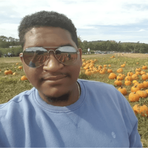 Tim standing in a pumpkin patch
