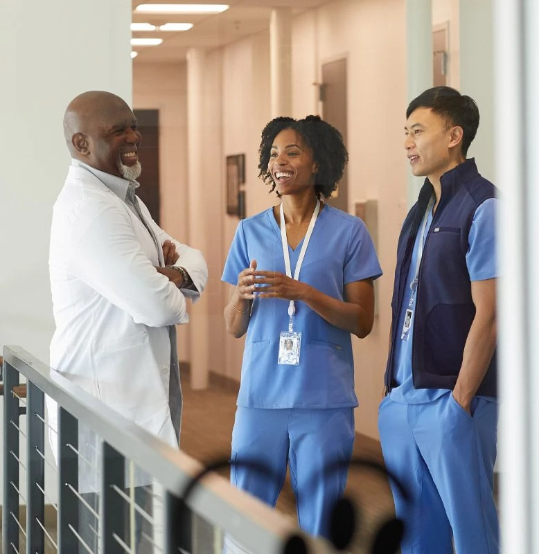 A diverse group of healthcare workers have a cheerful conversation