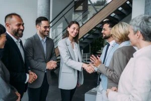Business persons handshaking during a meeting in modern office.