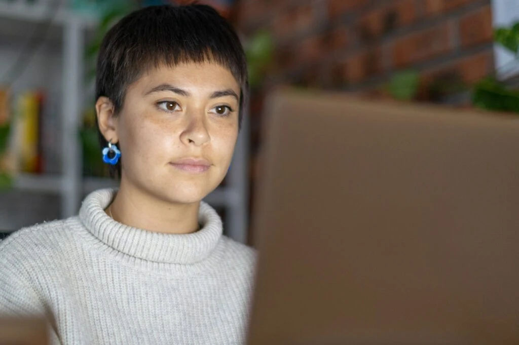 woman looking at her computer screen