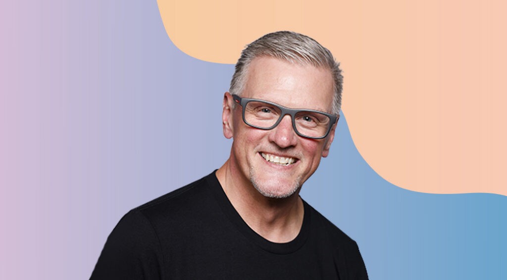 Headshot of Matt Berndt. Matt is a white man with short, light colored hair, black thick-rimmed square glasses, and a black tshirt.
