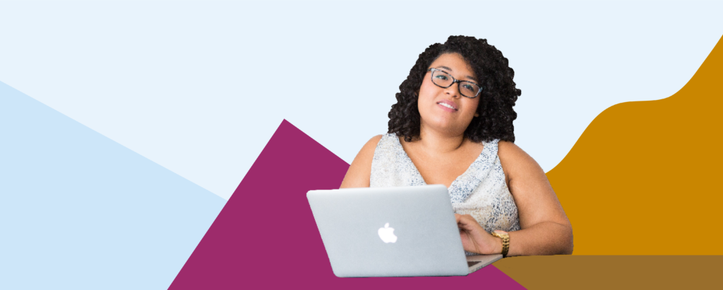 Woman working at a laptop and smiling