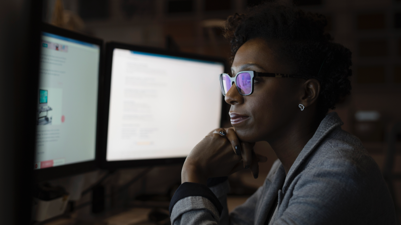 A woman looking at her computer screen