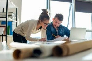 Man and woman reviewing work documents together