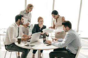 A group of five coworkers collaborating in an office