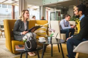 Two office people in a cafe setting