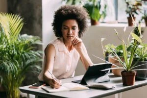 Pensive Mid Adult Mixed Race Businesswoman Working in her Home Office