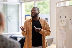 Man giving a presentation to the team in an office
