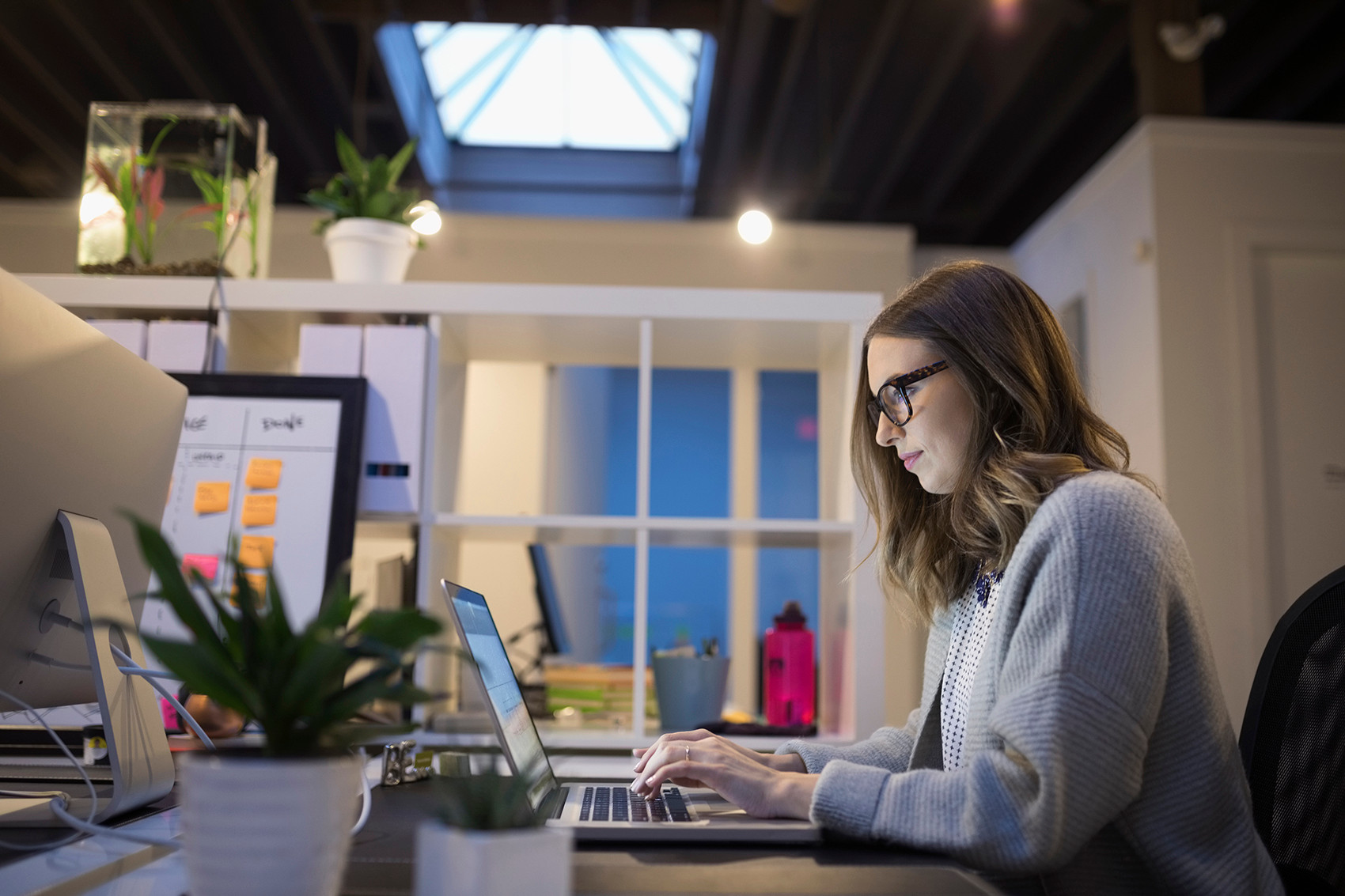 Une femme qui est sur son ordinateur dans un bureau