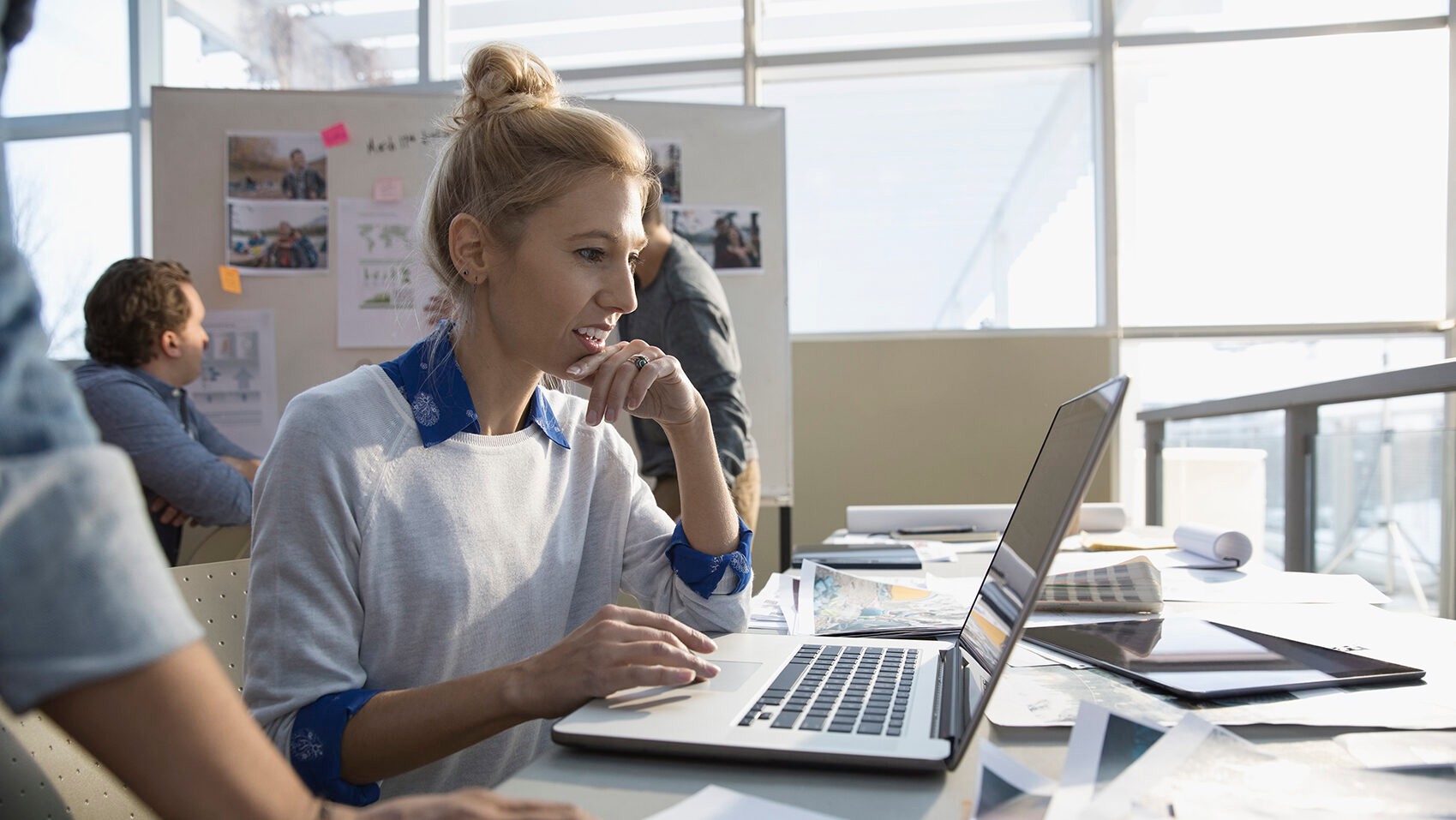 Creative female designer working at laptop in office
