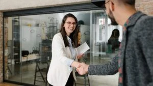 Man and woman shaking hands after an interview