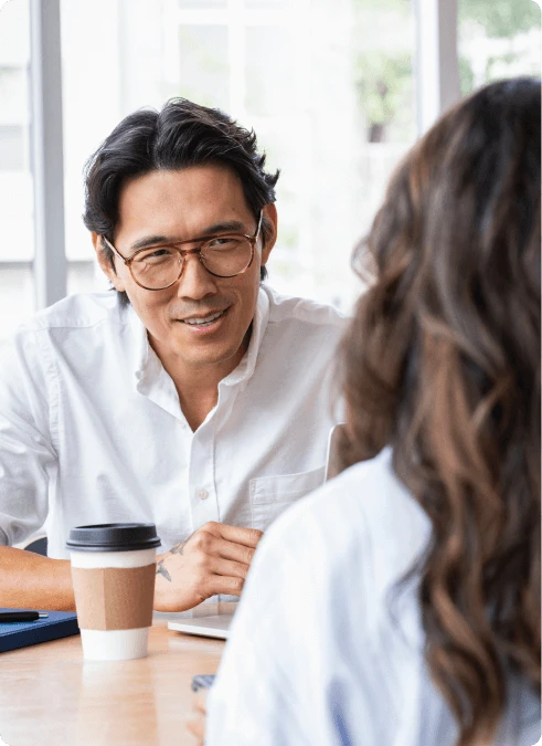 Man speaking with woman in a conference room