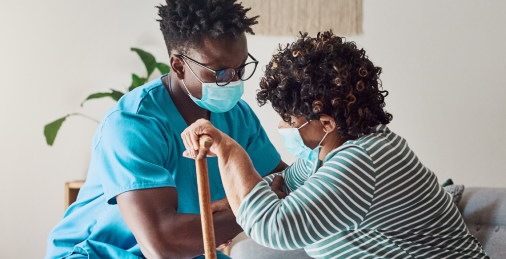 Shot of a young male nurse helping an elderly patient stand