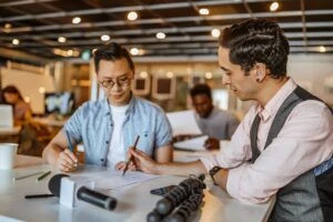 Two businessmen analyzing document at office