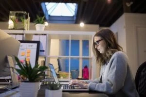 Person working on laptop in an open office