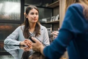 A young woman being mentored by a coworker in an office