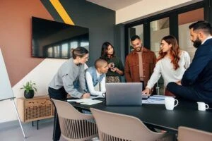 Diverse businesspeople discussing some reports in a boardroom.