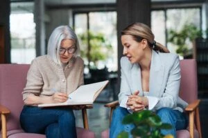 Dos mujeres sentadas y conversando